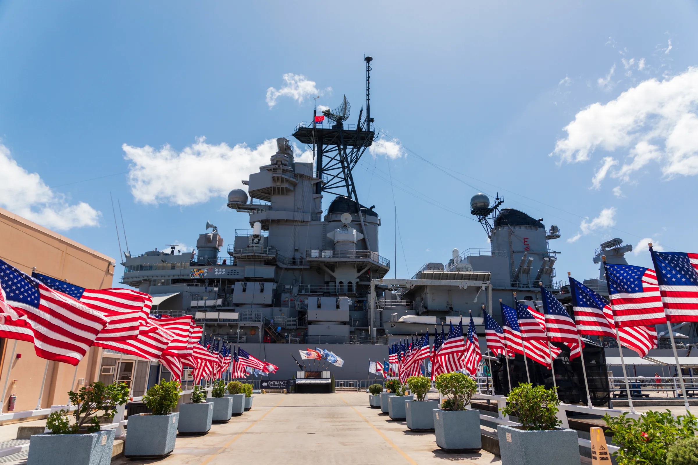 Row of American flags along the pier beside the Battleship Missouri
