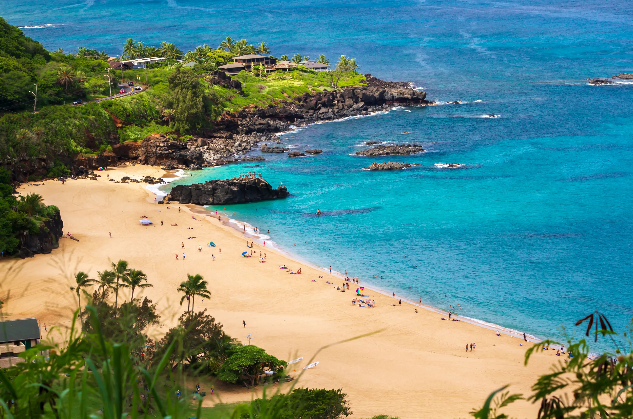Waimea Bay beach and its turquoise water seen from a hillside lookout